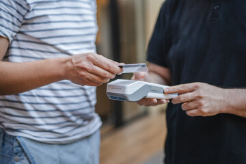 Unknown adult man have contactless payment with credit card