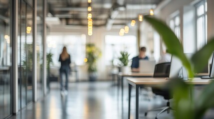 Obraz premium Two professionals are engaged in work at desks in a contemporary office filled with greenery, illuminated by natural light