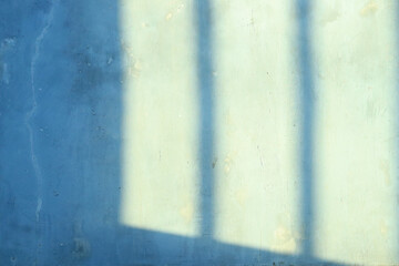 yellow shadow and light blur abstract background on gray wall from window. 
the striped shadows on the walls of the house are gray with the sunlight in the afternoon