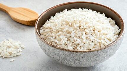 A bowl filled with uncooked white rice, offering a fresh and clean appearance, ideal for culinary or food-related projects.