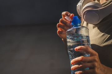close up hands unknown caucasian woman open plastic bottle of water