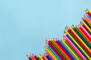back-to-school concept, colored pencils stacked in a row in the corner, empty space. High quality...