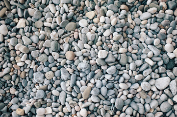 Texture of beach pebble close up top view.