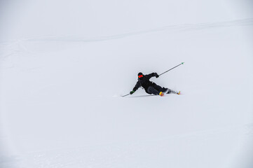 Skier man in action. Front view. Fast descent at high speed. Skier on skis in high mountains....