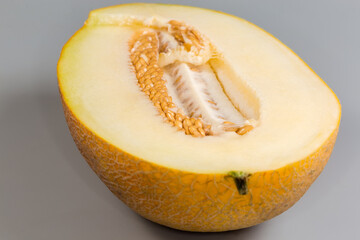 Half of yellow melon with seeds, close-up, selective focus