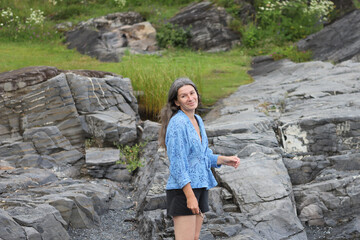 Woman on stone beach. Woman by the fjord in Norway, Oslo.