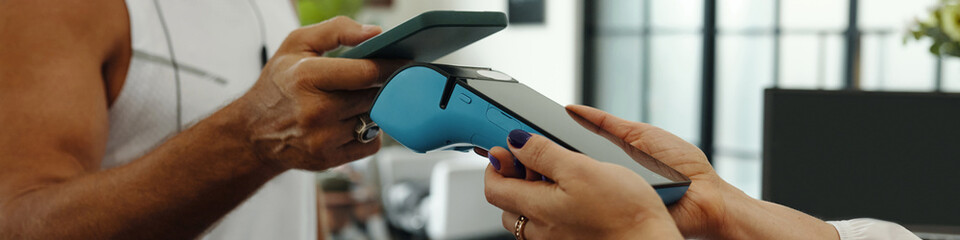 Header with man paying with mobile phone for training