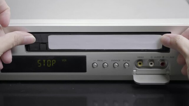 VHS videocassette is put into the VCR to watch the