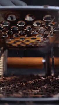 Making chocolate shavings on a hand-held tempera. 