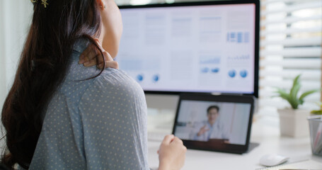Asia people young woman worker work at home job video call telemedicine online clinic app for workforce care meet chat or tele consult to doctor remote advice teach to relax stiff neck or wrist pain.