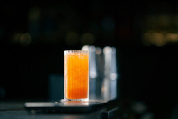 close up Cocktail with orange on bar counter in restaurant pub Orange drink with juice Fresh...