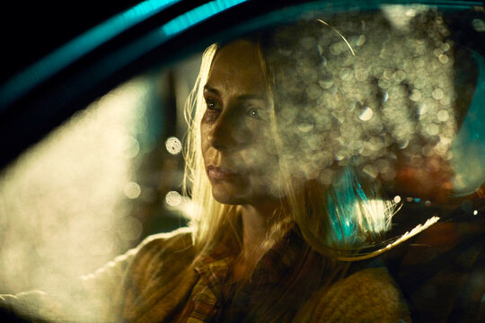 Woman driving at night with bruises on face