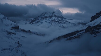 Fototapeta premium A high-angle shot of snowy mountains covered with clouds during a dark evening , ai