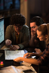 Team of architects collaborating on project in modern office