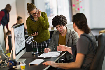 Team of architects collaborating on project in modern office