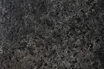 Smooth and polished black stone.