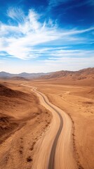 Fototapeta premium Aerial of a vast desert landscape with a solitary road cutting through, illustrating the isolation and expanse of the natural environment