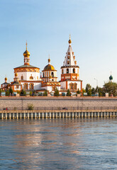 Siberia. Irkutsk. View from Angara river to historic city center with Epiphany Cathedral in Russian Baroque style of 1741- main landmark of city. Beautiful summer cityscape