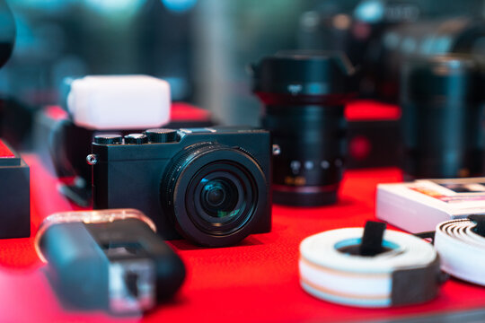 Black design mirrorless camera. Cameras behind the shop window. Photographer's equipment.