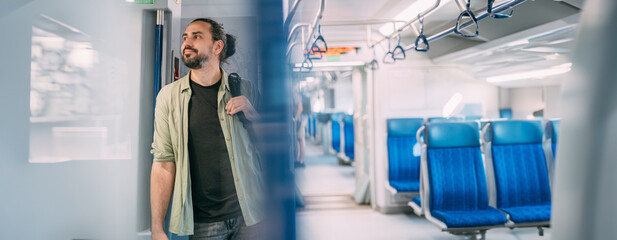 Fototapeta premium A Caucasian man rides on the train, in the skytrain, in the subway. Urban transport.