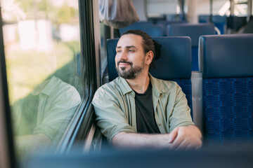 A Caucasian man rides on the train, in the skytrain, in the subway. Urban transport.
