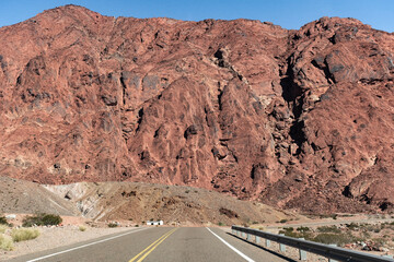 Ruta al lado de montañas rojizas.