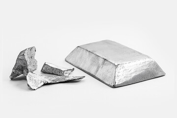 ingot and metal bar next to metal ore, material used in general