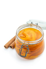 Marinated pumpkin slices in a glass jar isolated on white