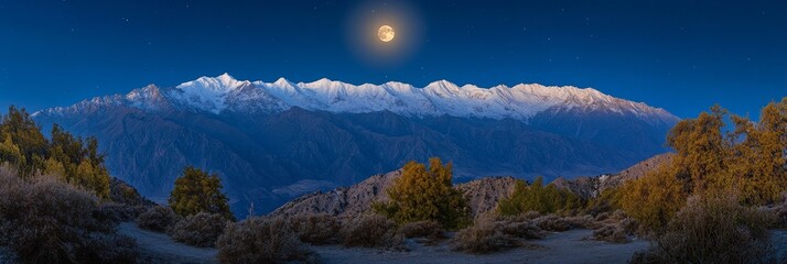Obraz premium At blue hour, the full moon is rising over distant mountains