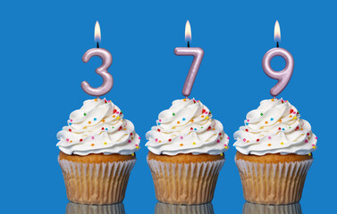 Birthday Cupcakes With Candles Lit Forming The Number 379