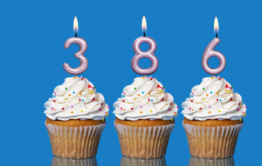 Birthday Cupcakes With Candles Lit Forming The Number 386