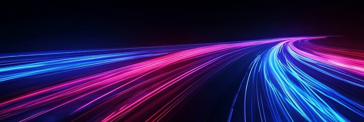An illuminated highway illuminated by passing cars creates vibrant light trails in the night sky