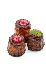 Canelé with raspberry jam isolated in white background