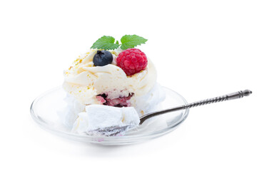 Mini Pavlova meringue nest with berries and whipped cream isolated on white