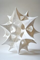 Abstract white geometric sculpture with intricate patterns.