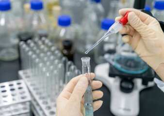 In the chemistry lab, scientists are doing chemical experiments with test tubes