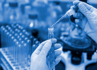 In the chemistry lab, scientists are doing chemical experiments with test tubes