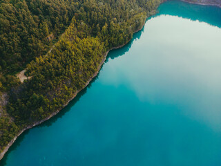 Fototapeta premium Aerial drone top down view of lake among forest, Nordrhein westfalen, Germany in summer day.