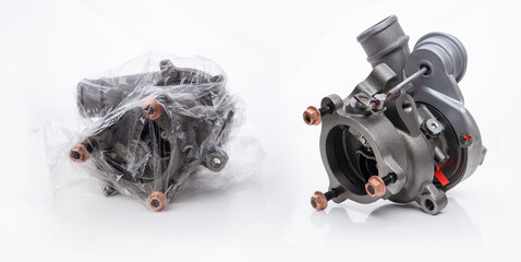A car turbocharger, both in a transparent bag and without it. High-performance turbo compressor...