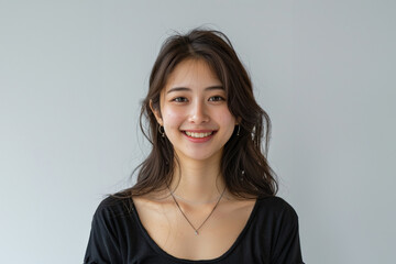 Fototapeta premium With a blend of casual and professional attire, this woman exemplifies modern office fashion while maintaining a clean, simple style.