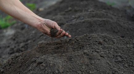 a man holds soil in his hands close-up. Selective focus