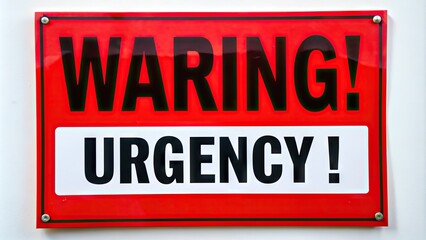 Fototapeta premium Bright red warning poster with bold black font and exclamation mark, conveying a sense of urgency and importance, against a stark white background.