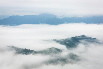 Mountains and clouds. Mist over the hill and forest.