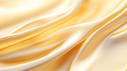 Fototapeta premium Elegant, flowing silk fabric in soft yellow tones, perfect for backgrounds, fashion, or textile-related projects.