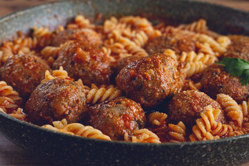 minced meat meatballs, in tomato sauce, with fusilli pasta, in a cast-iron pan, homemade, no people,