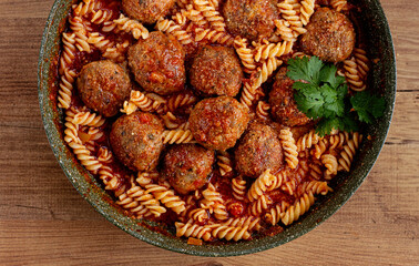 minced meat meatballs, in tomato sauce, with fusilli pasta, in a cast-iron pan, homemade, no people,