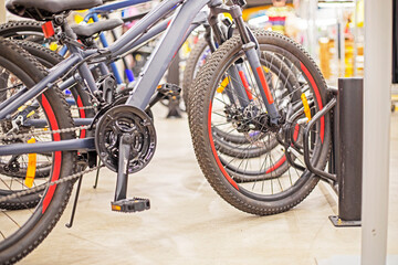 Fototapeta premium sports universal bicycles in a sports supermarket. Active recreation with family. Sport is expensive. Everyday life