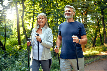 Active and Engaged Seniors Delight in a Nature Walk in the Park Using Nordic Poles