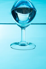 Glass in water  isolated on blue background.
