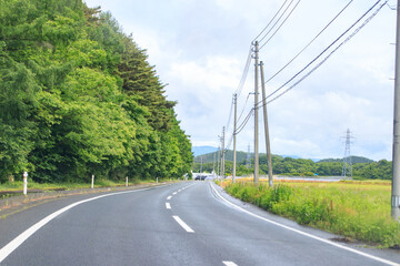 A Winding Road Through Lush Green Hills